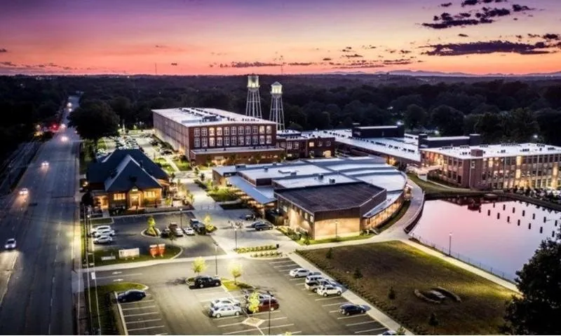 Aerial view of the Drayton Mills campus and Marketplace at sunset in Spartanburg, SC