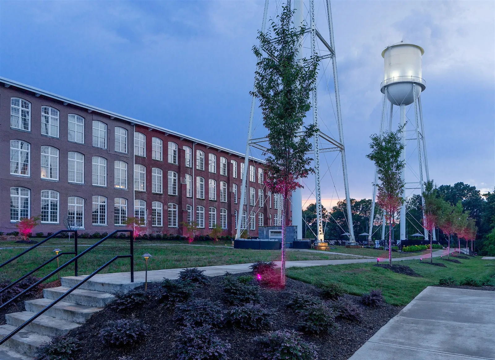 Drayton Mills Lofts exterior with water tower at dusk