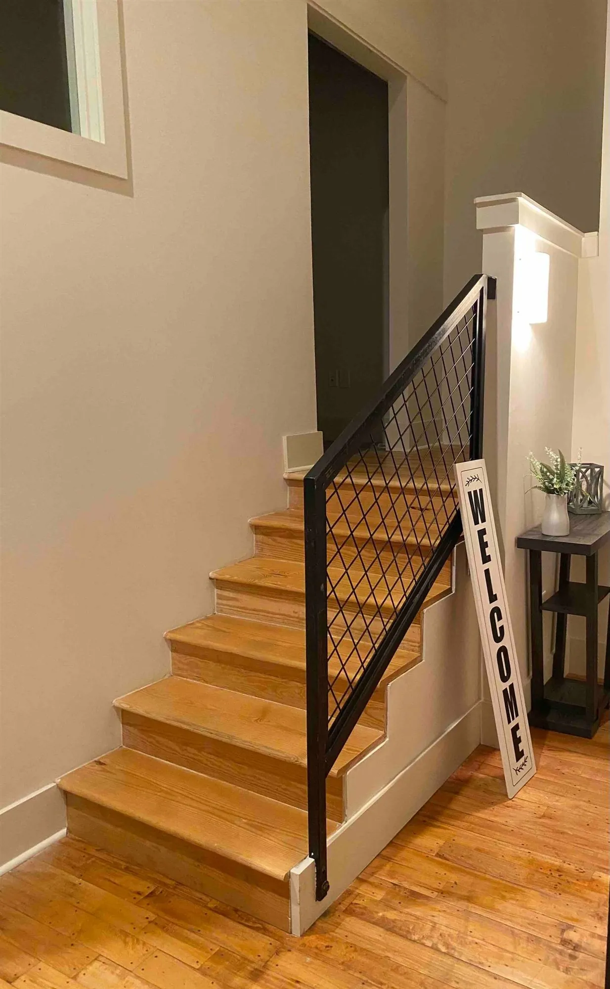Staircase up to the loft primary bedroom in a two bedroom loft at Drayton Mills