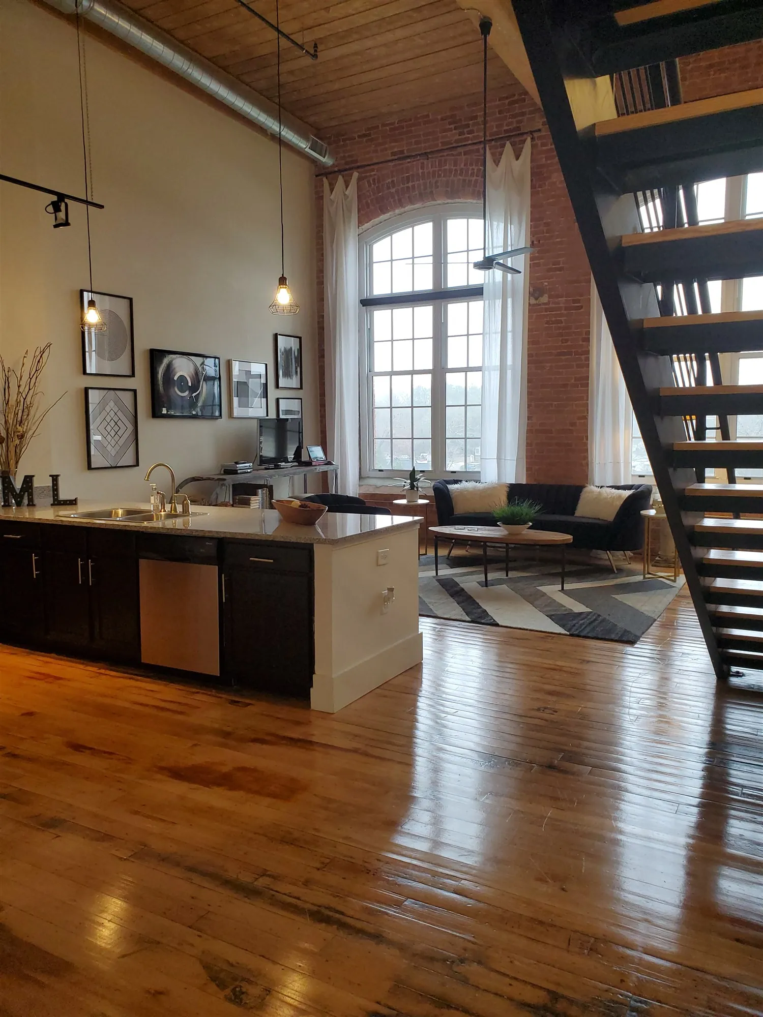 Steel staircase beside the kitchen in Spinning three bedroom model loft S325 at Drayton Mills