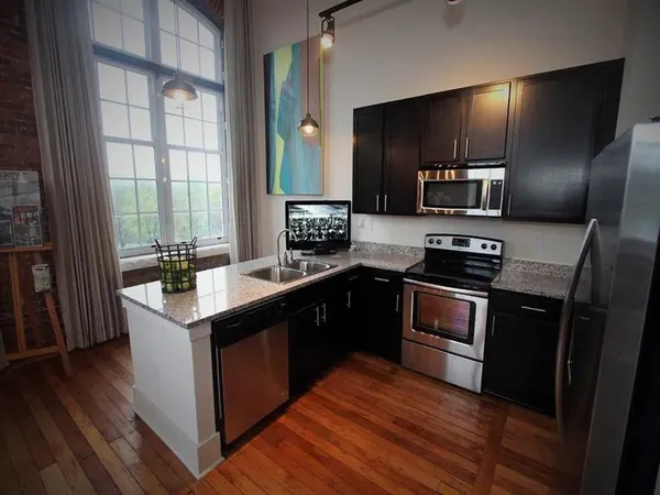 Granite countertops and stainless steel appliances in a Drayton Mills loft kitchen