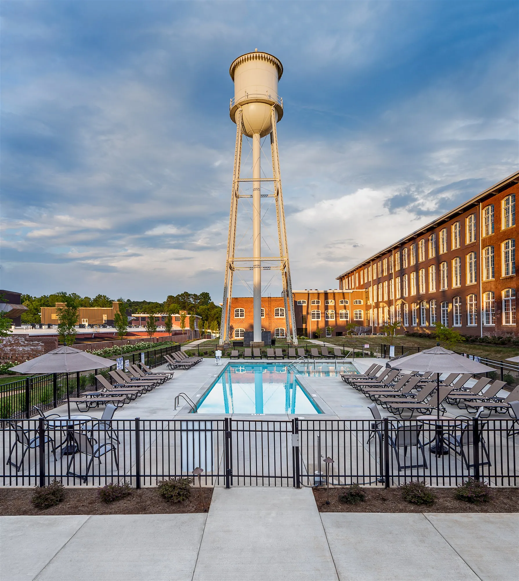 60-foot saltwater lap pool beneath the twin water towers at Drayton Mills Lofts in Spartanburg SC